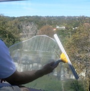 squeegeeing a window clean
