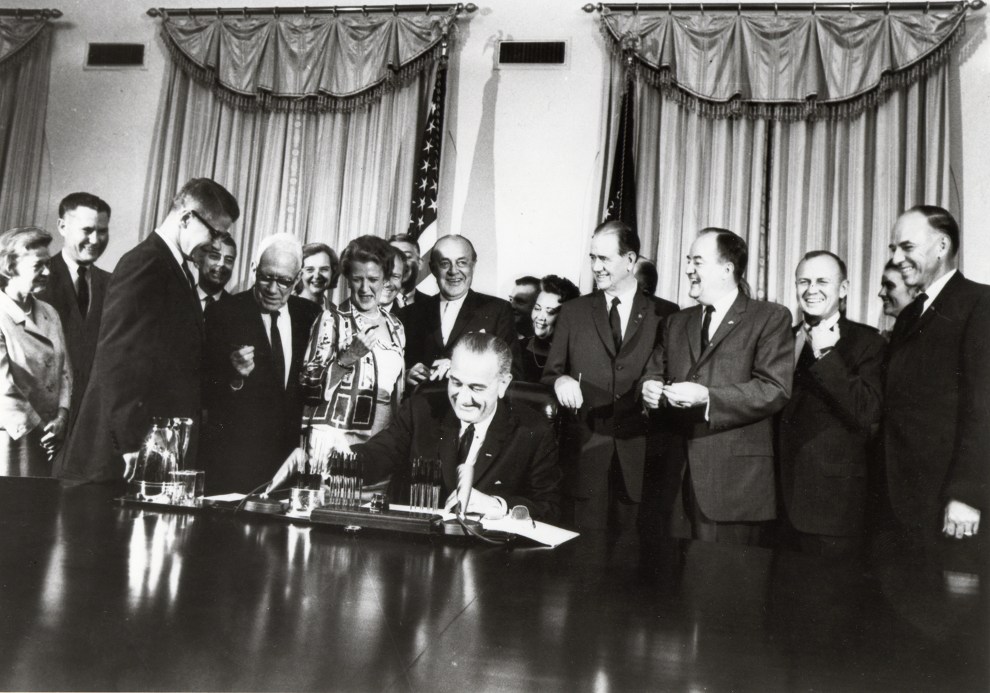 U.S. President Lyndon B. Johnson signing the Food Stamp Act of 1964.