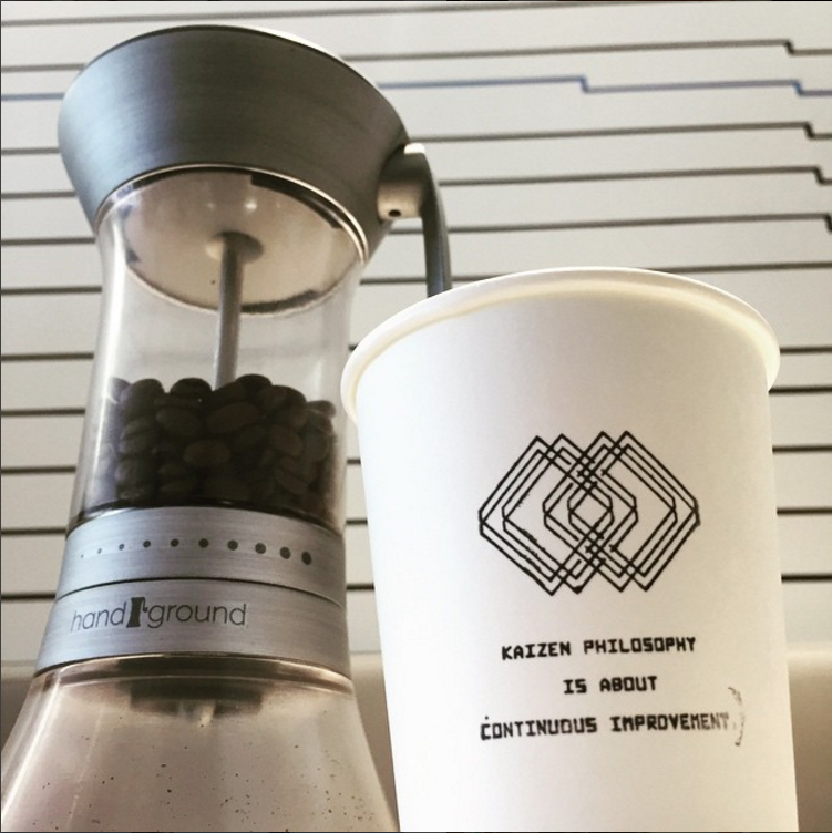 Handground prototype with coffee cup that says "Kaizen"