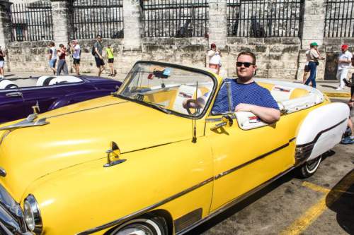 blog-Everything-You-Need-to-Know-to-Visit-Havana-Cuba-sitting-in-classic-car.jpg