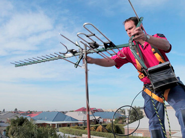 Picture of a man installing a TV aerial