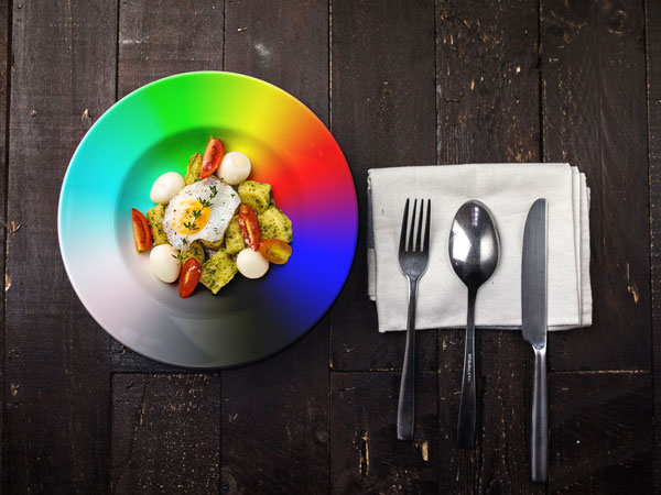 A rainbow colour plate with food on it showing how it affects the look of food.