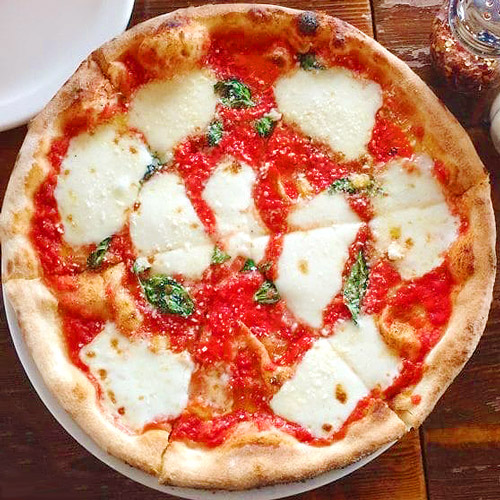 Full pizza with basil and mozzarella