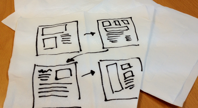 user experience designs sketched on paper napkin