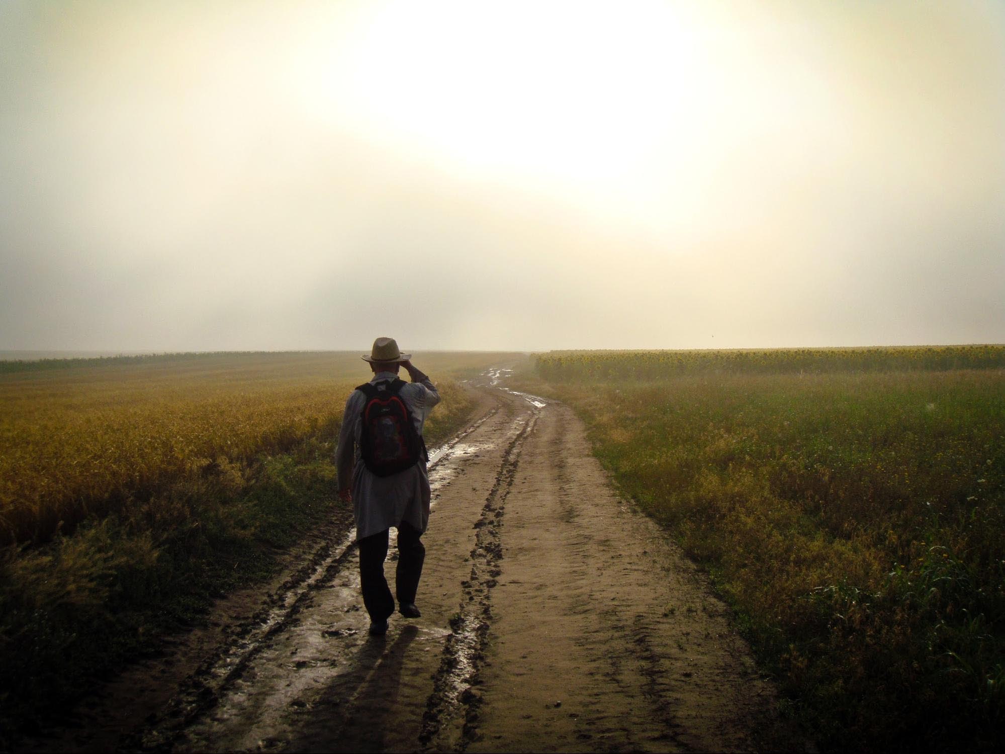 Man walks down dirt road