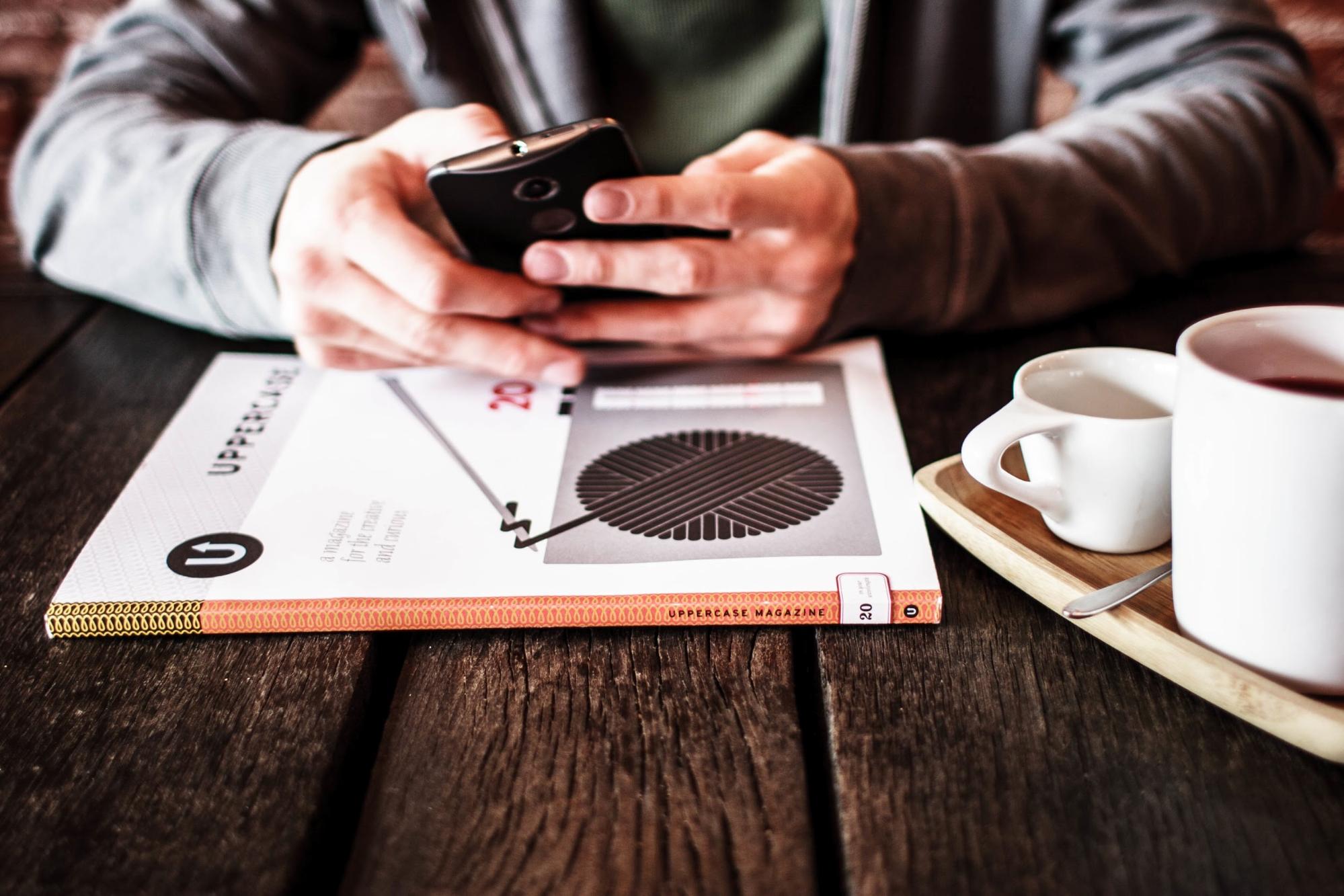 Man using smartphone in cafe