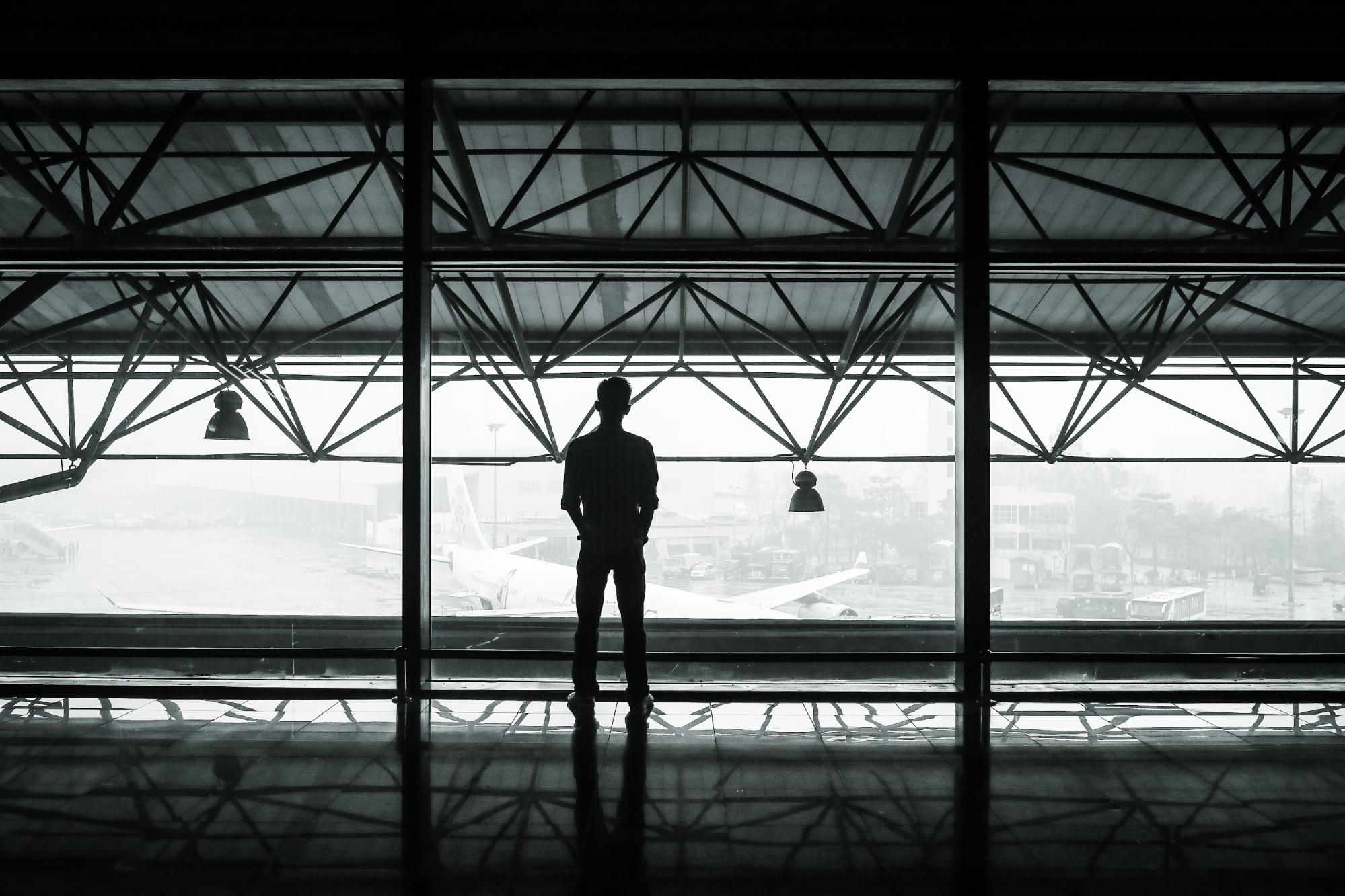 Man in terminal looking at airplane