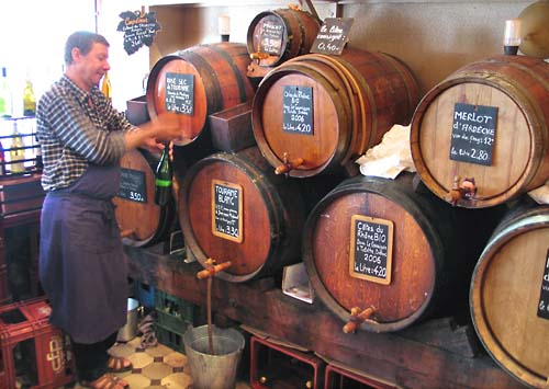 Barman filling up wine to go at Le Baron Rouge