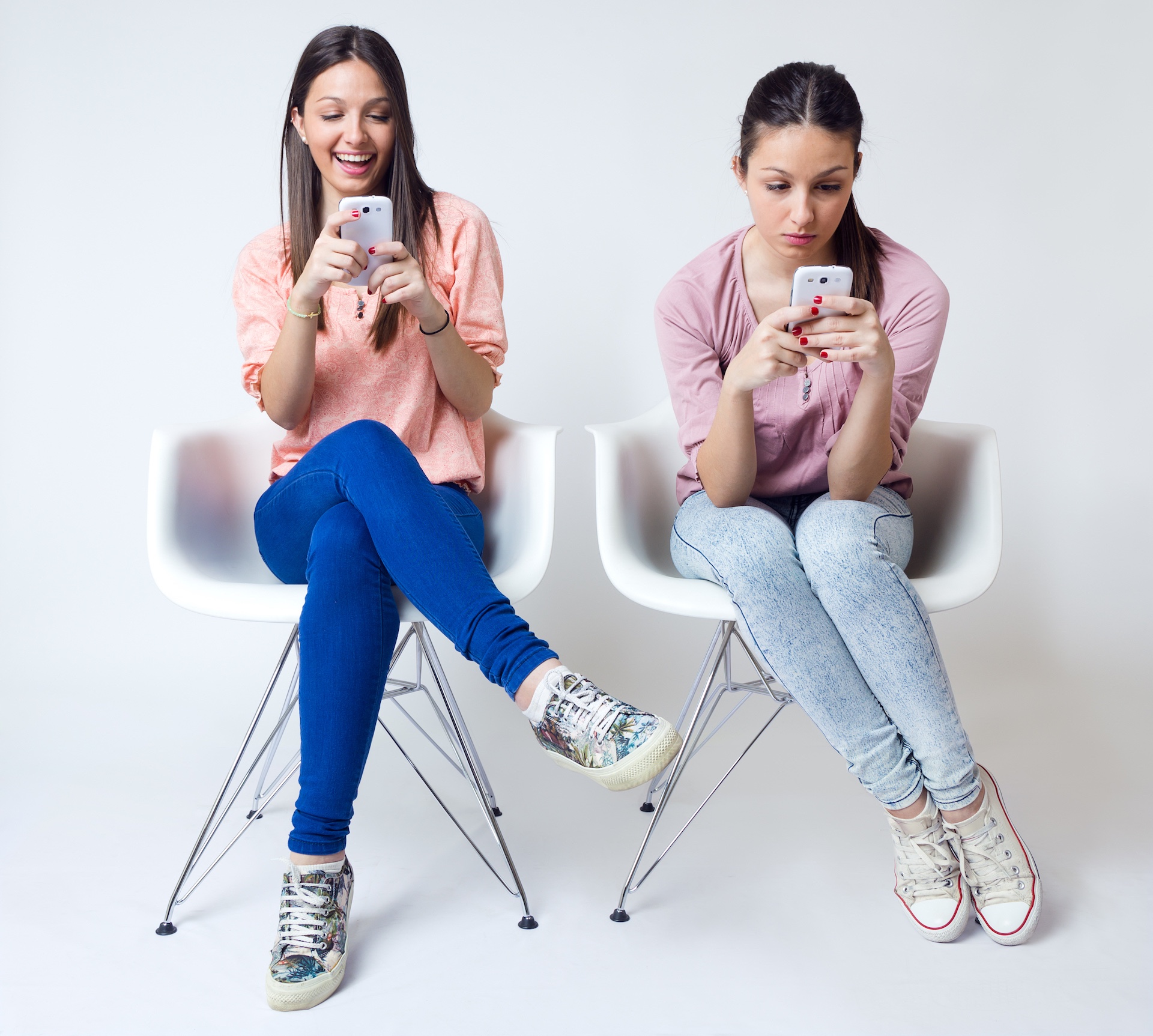 Two Girls Using Smartphones
