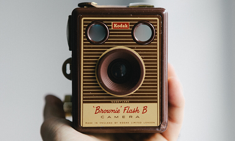 Person holding a Kodak Brownie camera