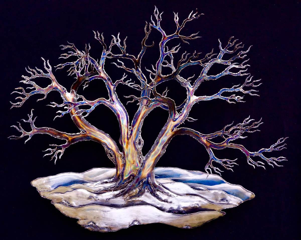 Metal snow laden tree sculpture