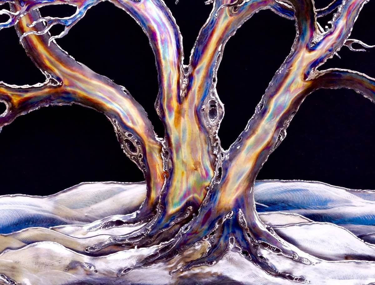 Close up of metal snow laden tree sculpture