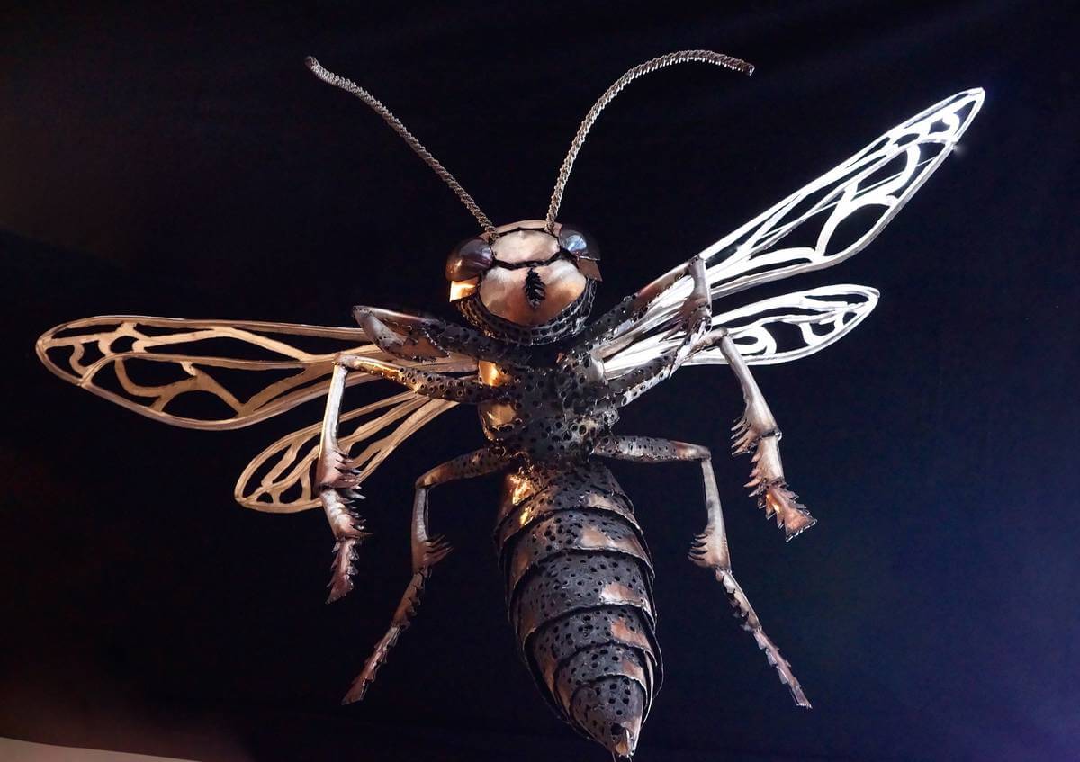 Metal wasp sculpture from below