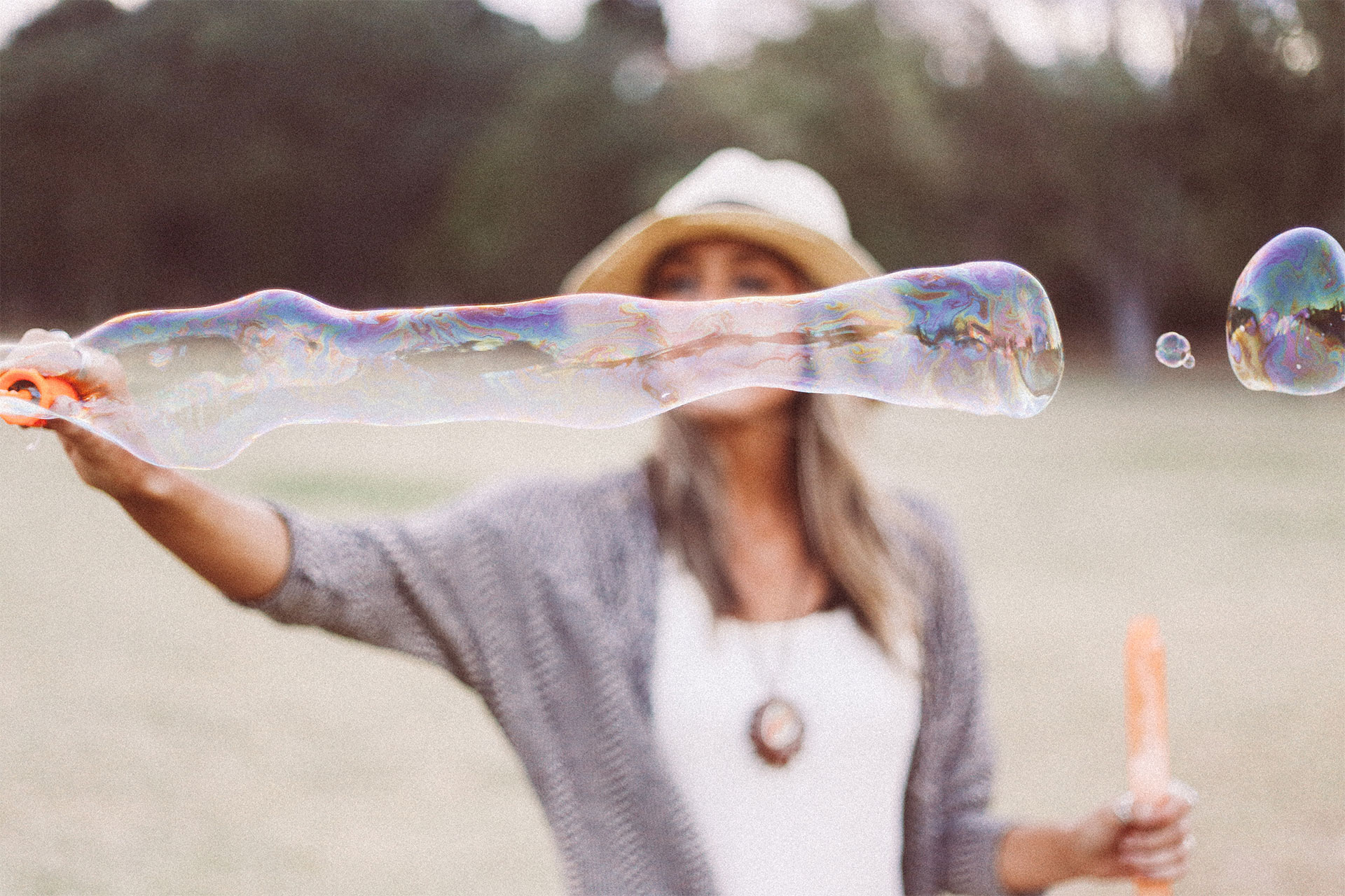woman playing with bubbles outdoors