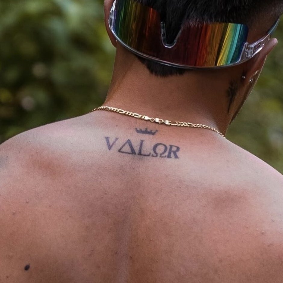Close-up of a Valor crown tattoo, a mark earned by top reps